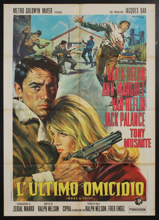 a movie poster with a man holding a gun and embracing a woman. in the background a man is being shot and a gun fight ensues.