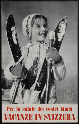 a smiling child in winter clothes holding skis and poles