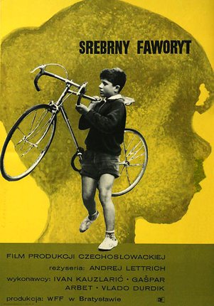 a boy holding a bicycle