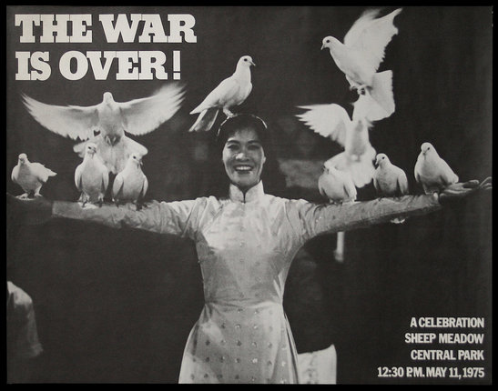 a woman holding pigeons on her arms