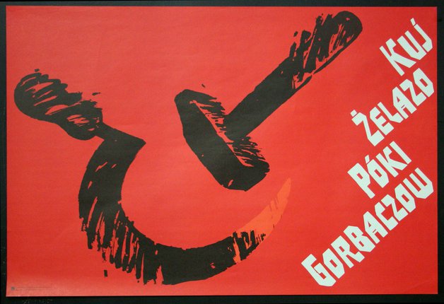 a red poster with black paint on it