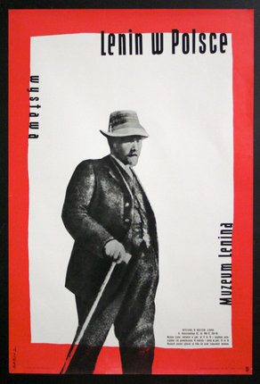 a man in a hat and coat holding a cane
