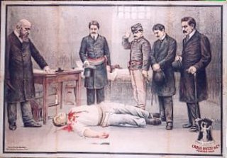 a group of men standing around a man lying on the floor