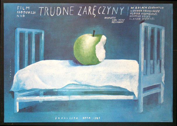 a poster of a green apple on a bed