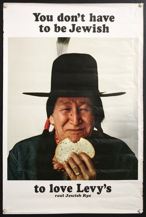 a man in a hat eating a sandwich