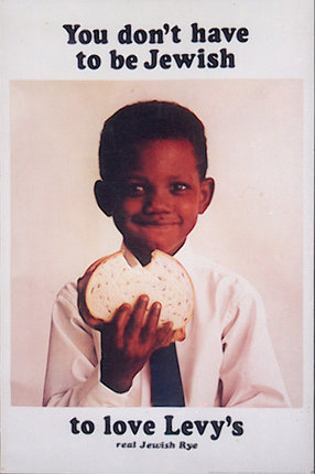 a young boy holding a sandwich