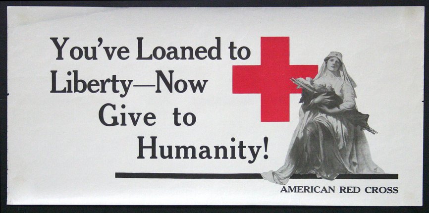 a white sign with a red cross and a statue