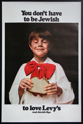 a boy holding a sandwich
