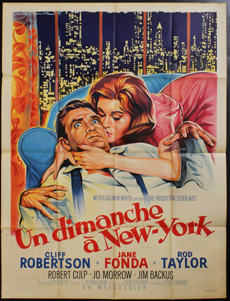 a movie poster of a man and woman on a couch