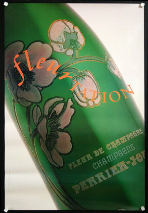 a green bottle with flowers on it