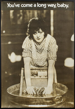 a woman washing clothes in a tub