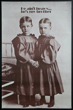 a couple of young boys dressed in old fashioned dresses