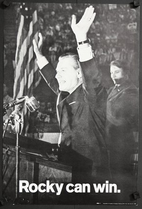 a man raising his hands in front of a microphone