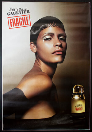 a poster of a woman with a gold bottle