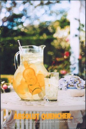 a pitcher of lemonade with ice and orange slices