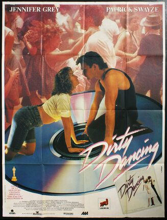 a movie poster of Patrick Swayze and Jennifer Grey sitting on a giant cd