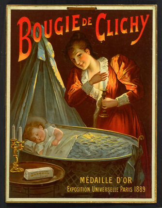 a woman holding a candle and a baby sleeping in a crib