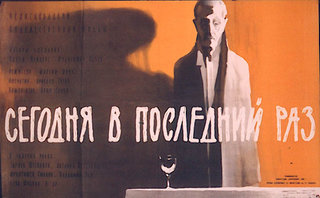 a man standing next to a glass of wine