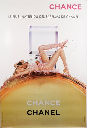 a woman lying on a perfume bottle