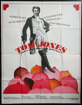 a poster of a man standing on a pile of red and pink balloons