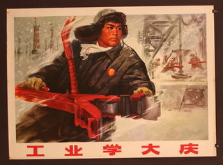 a poster of a man holding a red gun