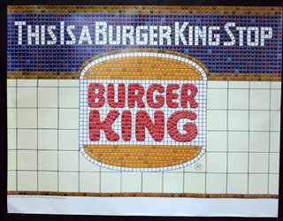 a poster of a a subway wall that's says, This is a burger king stop.