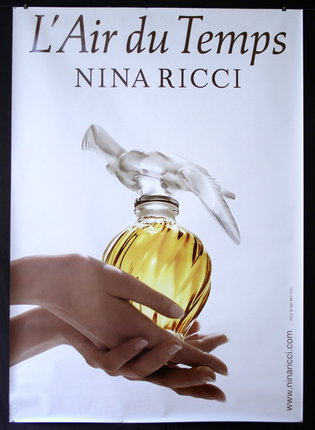 a poster of a woman holding a bottle of perfume