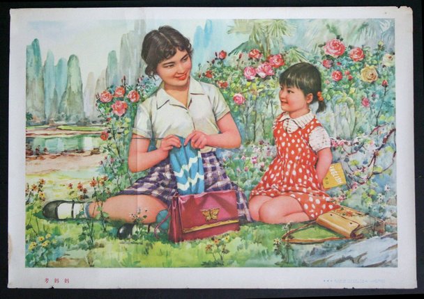 a woman and a child sitting on the grass