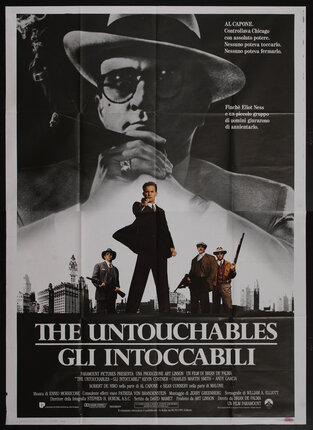 a movie poster with a man holding a cigar looming over a city with several men standing with guns on the horizon