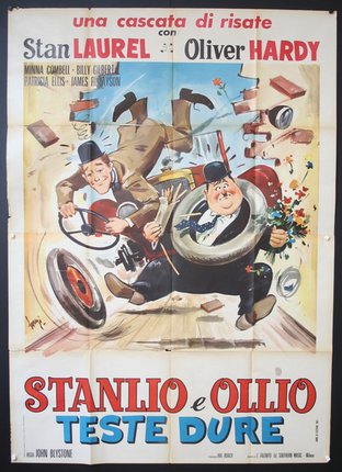 a movie poster of two men falling on tires