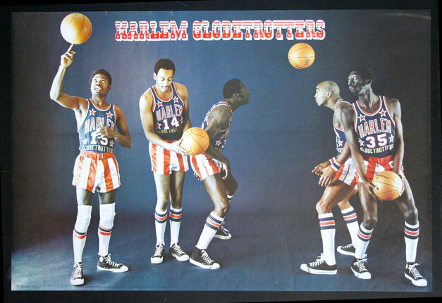 a group of men playing basketball