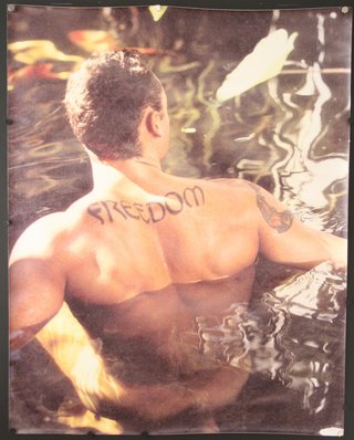 a man in water with tattoo on his back