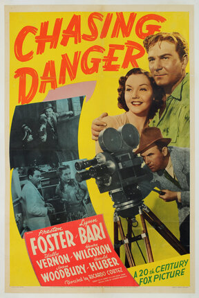 a movie poster with a man, woman, and a camera man.