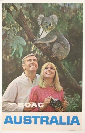 a man and woman with a koala in a tree