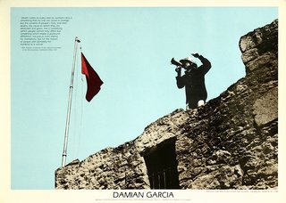a person standing on a stone wall with a flag