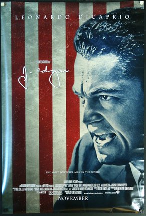 a movie poster with a man in front of a red and white striped background