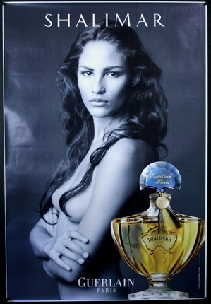 a poster of a woman with a bottle of perfume