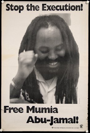 a man with dreadlocks smiling and fist raised