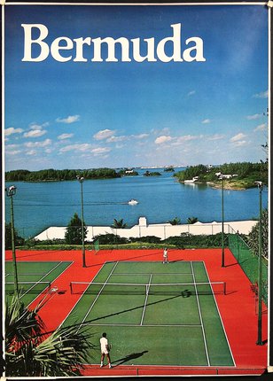a tennis court with water in the background
