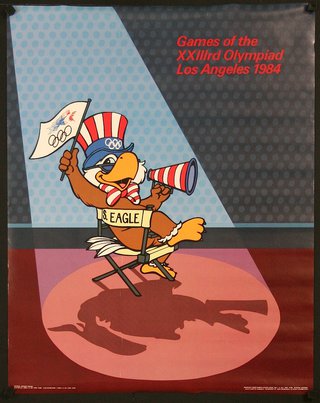 an eagle mascot sitting in a chair holding a flag