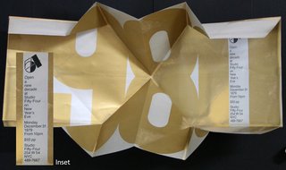 a folded paper with a white and gold design