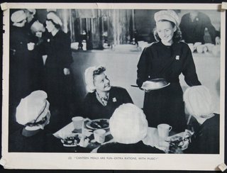 a group of women in uniform serving food