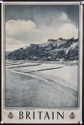 a poster of a beach with a building on the hill