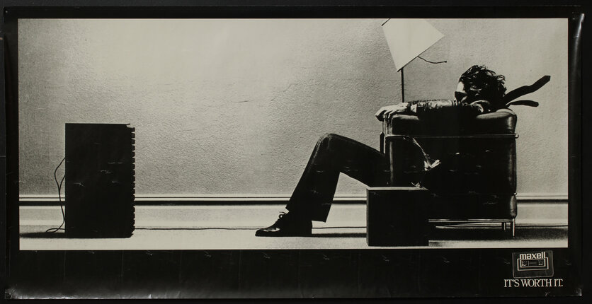 a black and white photo of a man sitting in a chair