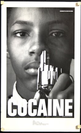 a close-up of a boy holding a gun