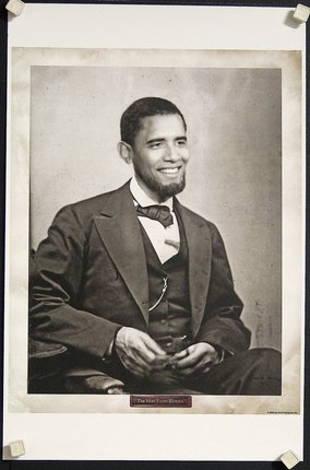 a man in a suit smiling with Seated Lincoln in the background
