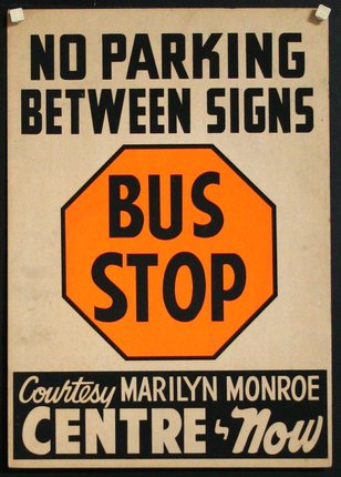 a sign with black text and orange octagon