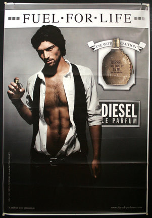 a man holding a bottle of perfume