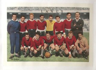a group of men in red shirts posing for a photo