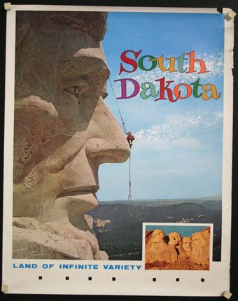 a poster of a man climbing a rock face